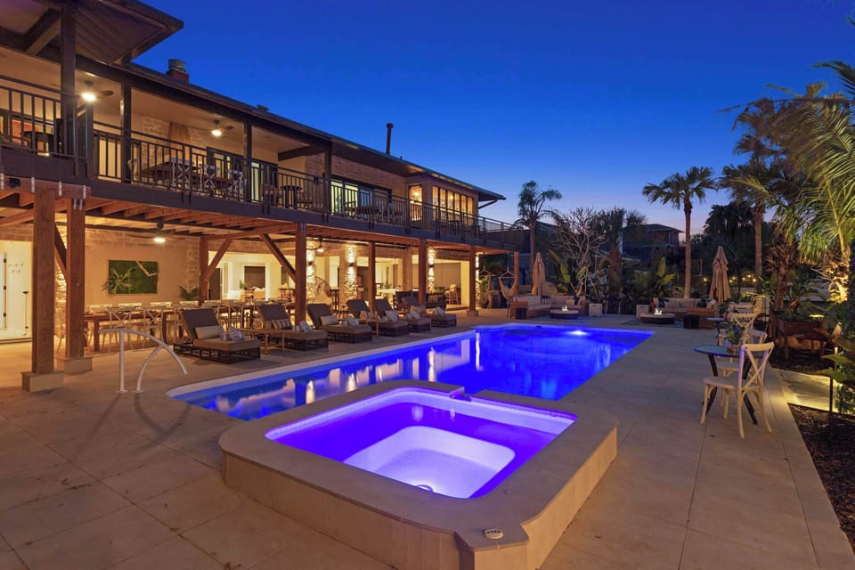 Outdoor Oasis: Dive into luxury with a vibrant pool and enchanting evening ambiance!