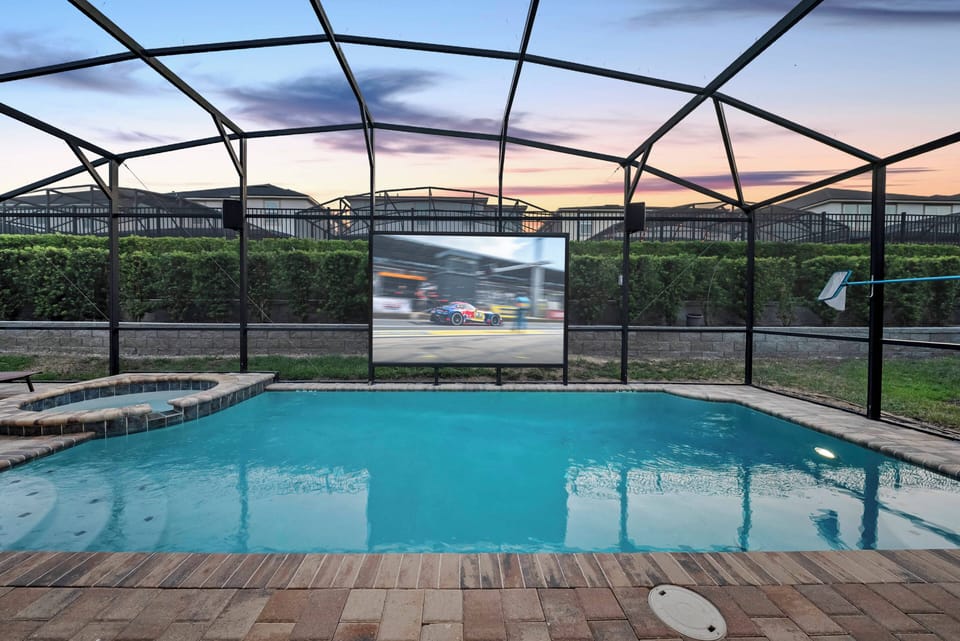 Experience your private oasis featuring a sparkling pool within a sleek screened enclosure for safety and breathtaking views. The elegant stone patio complements the serene waters, creating an ideal spot to relax as the sun sets.