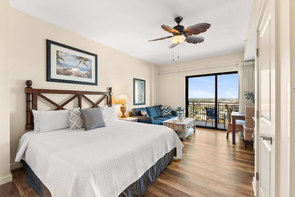Relax in your spacious bedroom with cozy seating area and private balcony offering stunning views beyond.