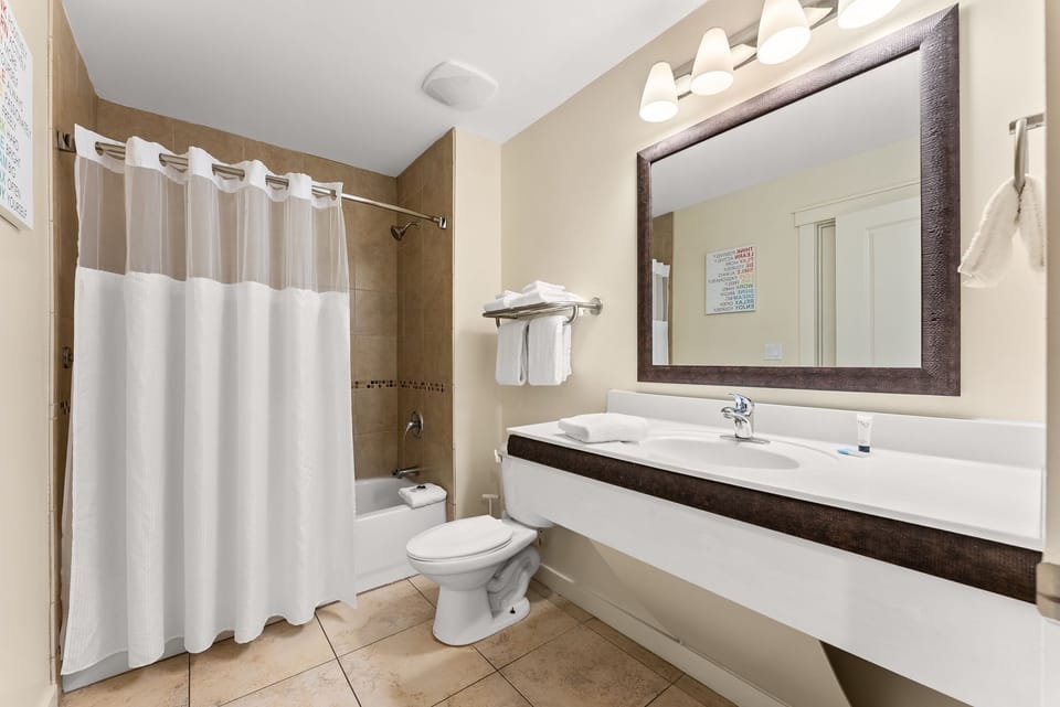 Your spacious bathroom features a relaxing tub-shower combo, granite vanity, and modern amenities for your comfort.