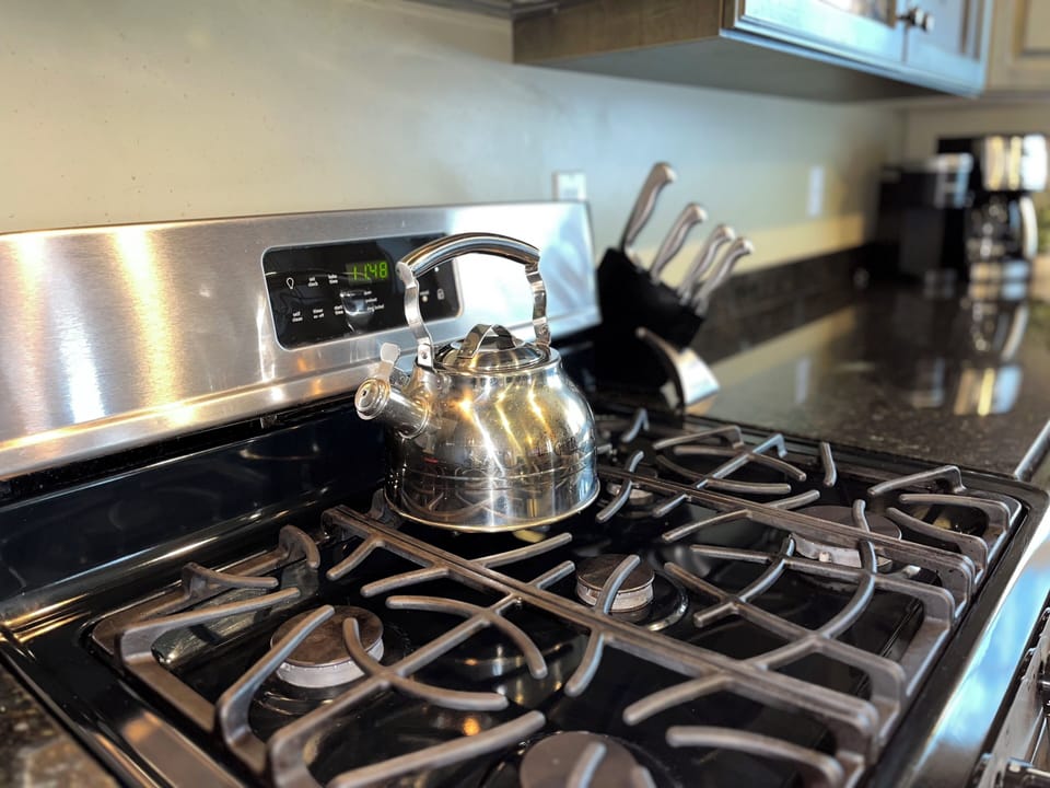 Cook your favorite meals in this fully-equipped kitchen featuring stainless steel appliances, granite countertops, and ample cabinet space for all your culinary adventures.
