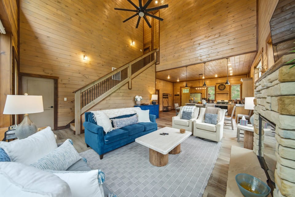 Step into your spacious retreat, where soaring wood-planked ceilings and a cozy stone fireplace welcome you home. Sink into plush seating, unwind in the open-concept layout, and let the warm glow of the loft create your perfect mountain escape.