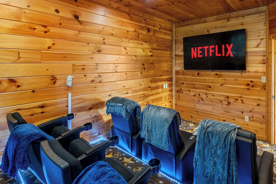 Private theater with tiered recliners with LED lights. Perfect for movie nights.