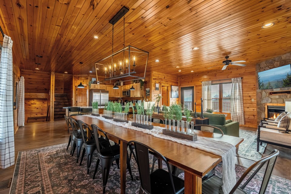 The open-concept main level features a long dining table that seats 12. 