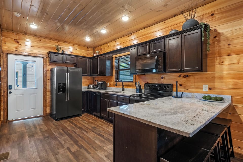 Rustic cabin kitchen with modern appliances and all you need to cook a meal. 