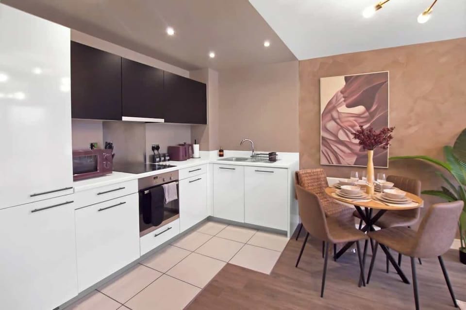 Sleek modern kitchen with integrated appliances and a stylish dining area ideal for enjoying meals during your stay