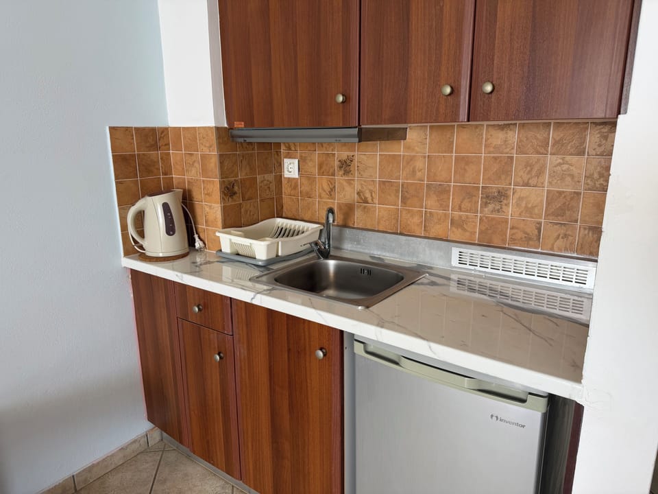 Standard Triple Room | Private kitchen | Mini-fridge, highchair, freezer, kitchen islands