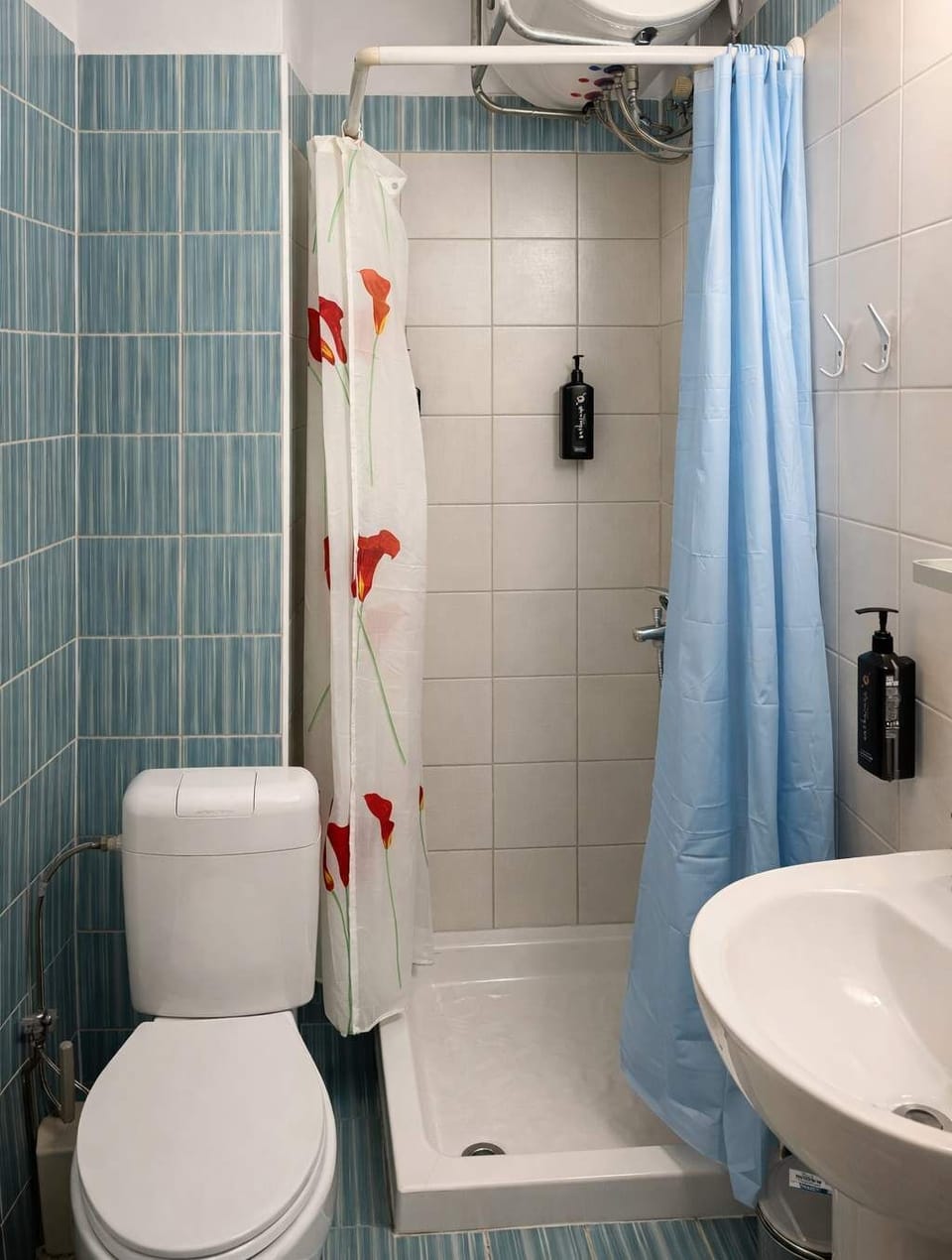 Clean and functional bathroom with shower, modern fixtures, and essential amenities, ensuring a comfortable and refreshing experience throughout your stay.