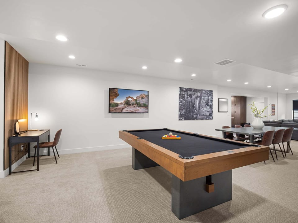 A modern pool table with lots of room to move plus a dedicated office space with monitor