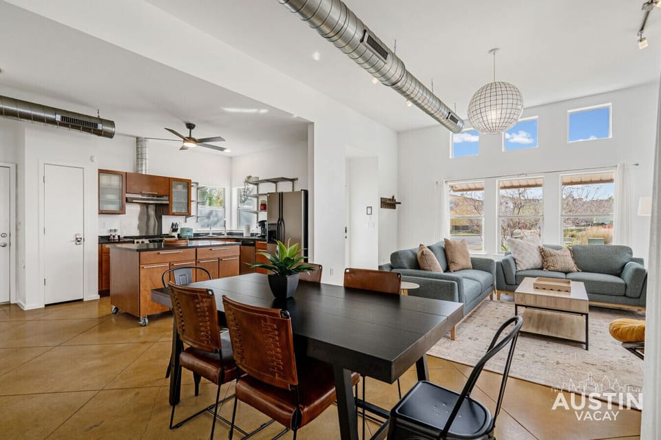 Open-plan main floor with dining, kitchen island, and living area in one view.
