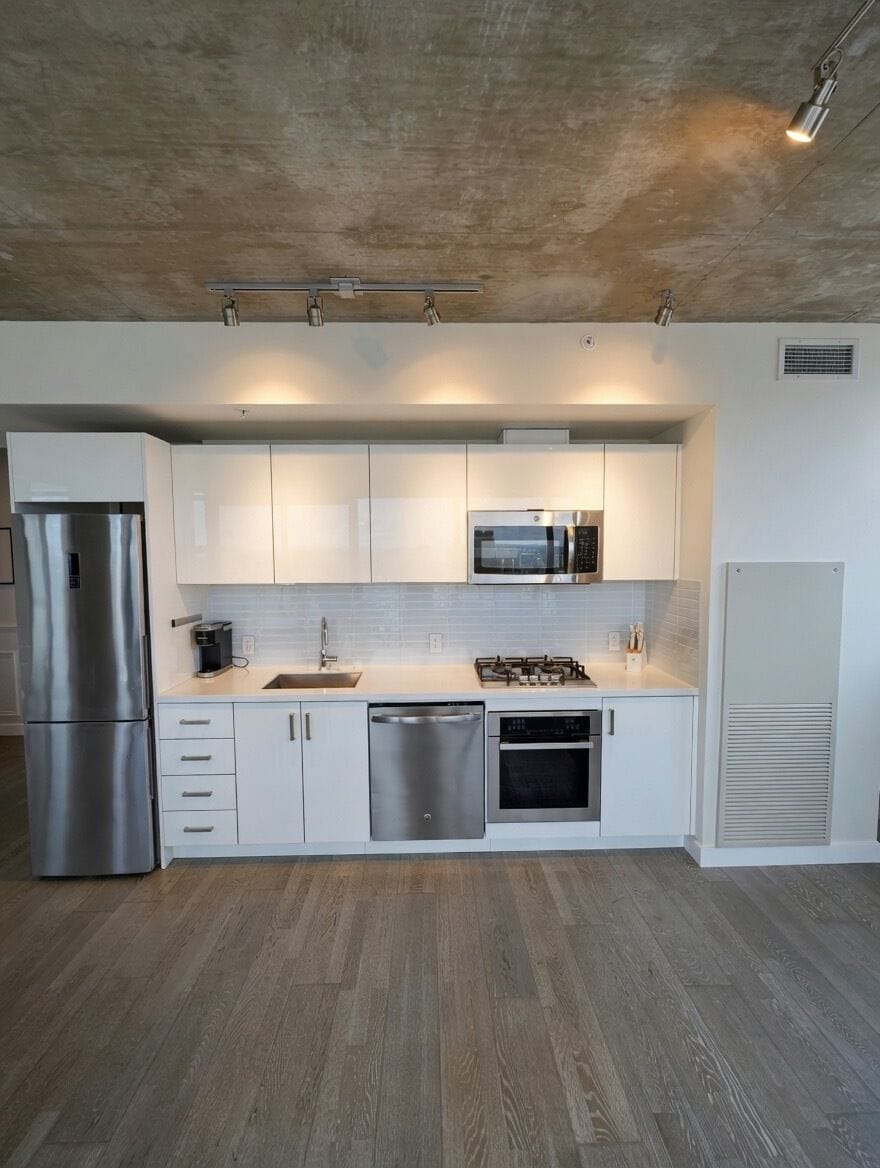 Cook, entertain, or enjoy a coffee in this sleek, fully equipped modern kitchen.