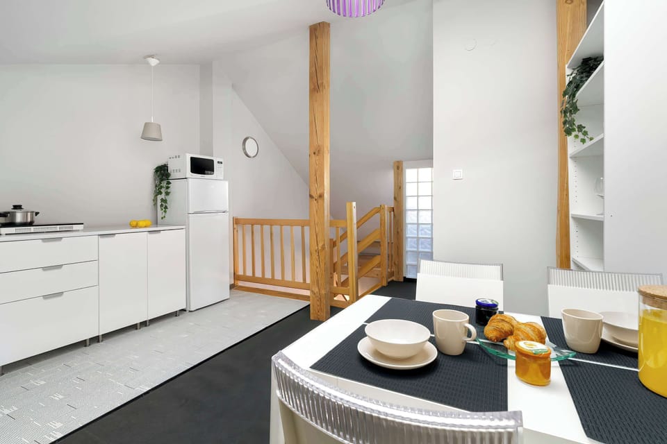 Another angle of the kitchen, showing more storage space and countertop area. The design is bright and modern.