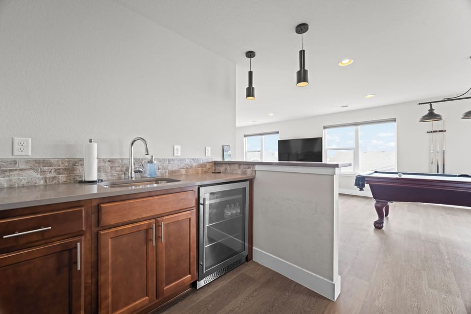 Top-floor hangout featuring wet bar and mini fridge.