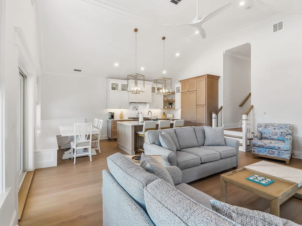 Living room area with a view of the dining and kitchen area 