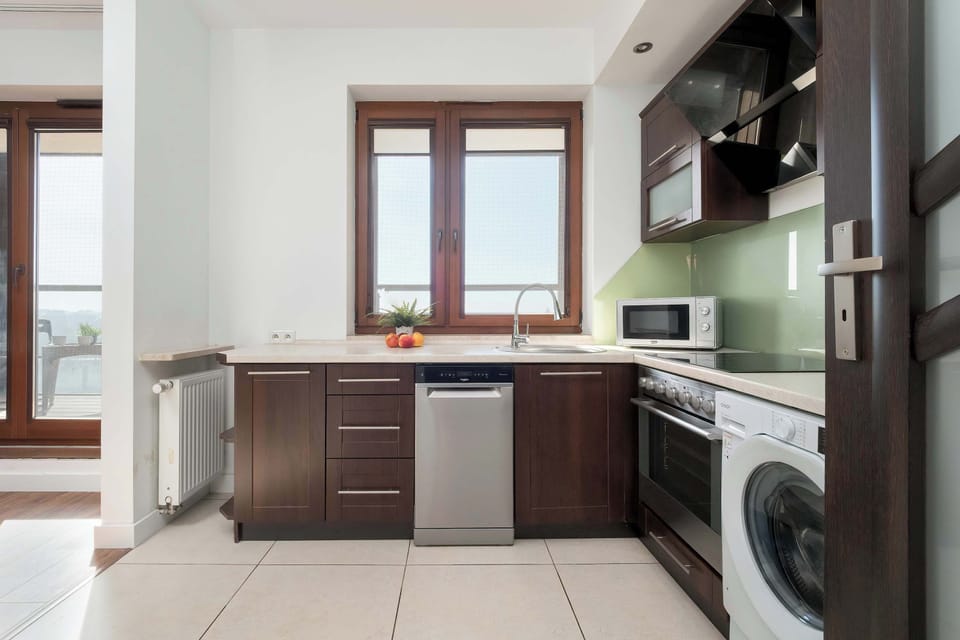 The kitchen showing additional cabinets and counter space. The layout looks practical and functional for everyday cooking.