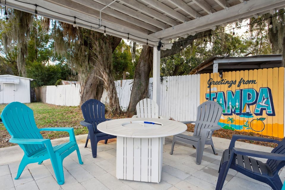 Cozy pergola and fire pit with artsy mural made by local artist