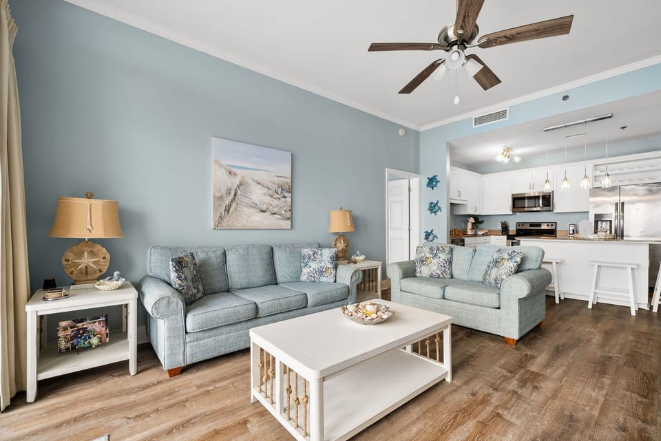 Unwind in your coastal-inspired living space with plush seating and modern kitchen nearby for effortless meal prep.