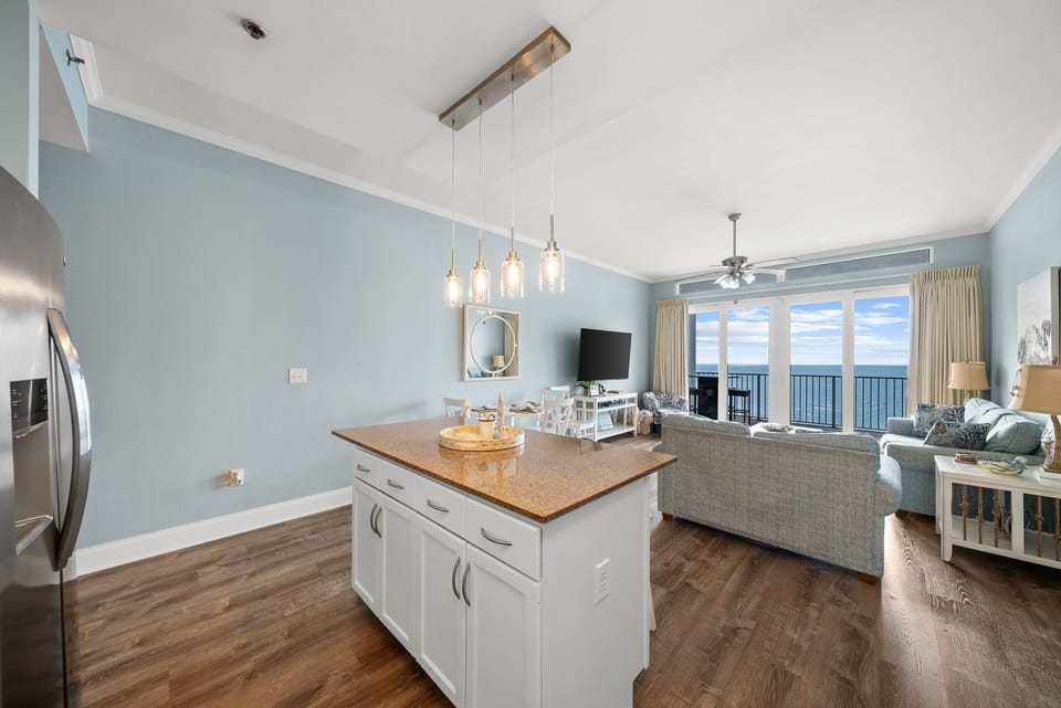 Unwind in this bright oceanfront space where your kitchen island overlooks sweeping sea views through floor-to-ceiling windows.