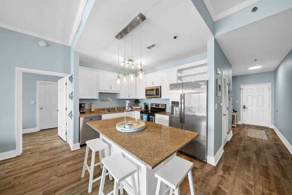 Your spacious kitchen awaits with granite countertops, stainless steel appliances, and a breakfast bar perfect for morning coffee or casual meals together.