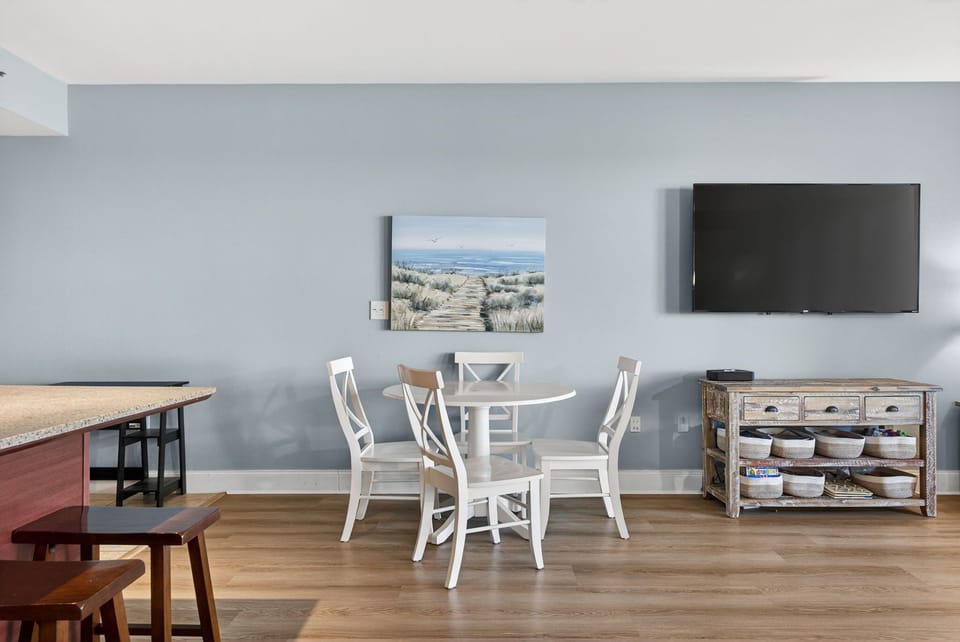 Relax in your bright dining area with coastal artwork and modern amenities for memorable meals together.