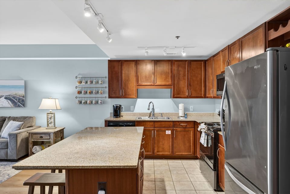 Your fully equipped kitchen features granite counters, stainless appliances, and warm wood cabinets—perfect for preparing meals together.
