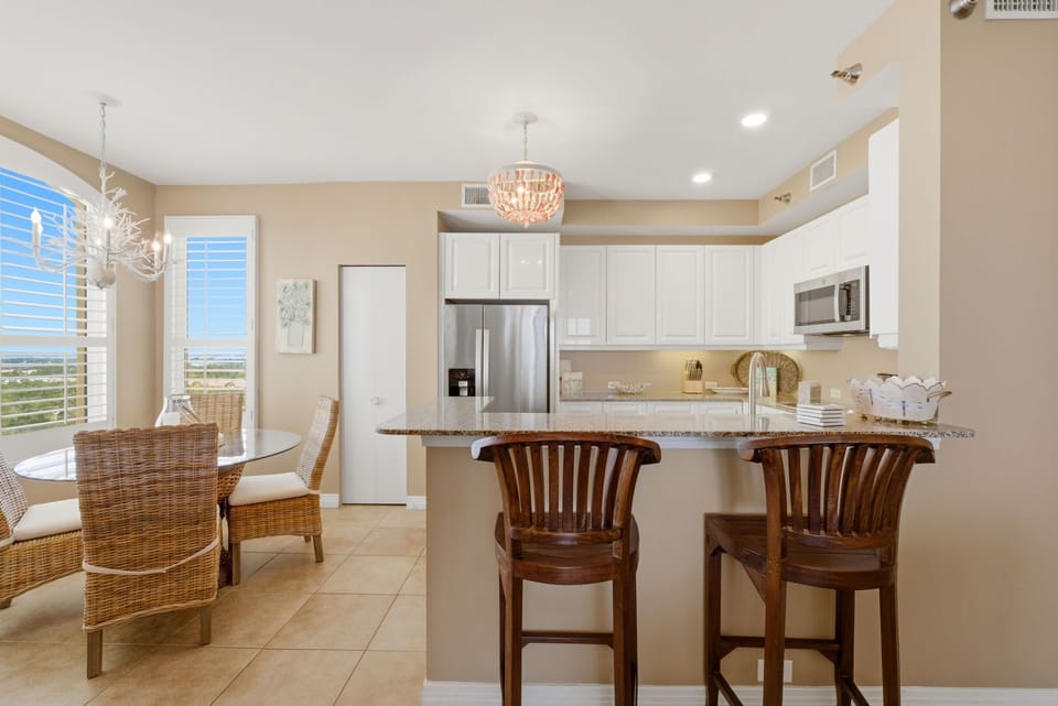 Beach Colony T PH1D- Gather around your granite breakfast bar or enjoy meals at the dining table—both with stunning views that make every moment feel special.