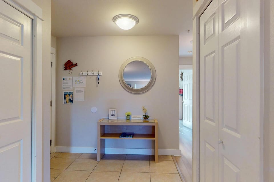 Entryway with table, mirror, and space for your belongings.