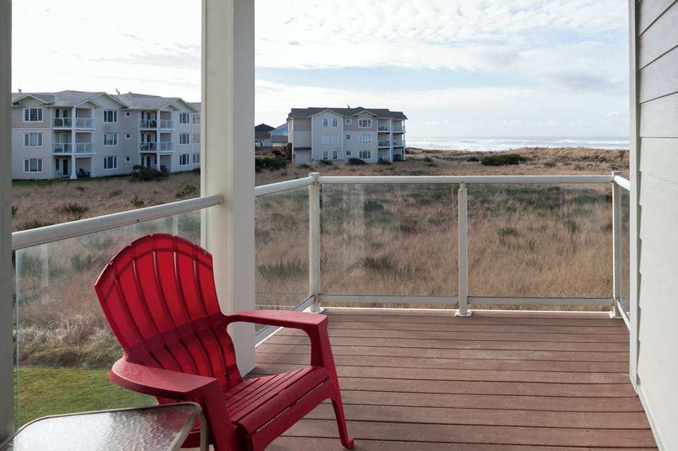 Private deck with seating and a view of the ocean perfect for enjoying fresh coastal air.