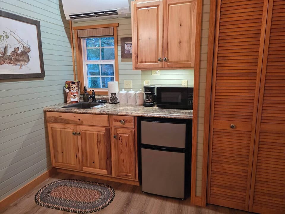 Mini Kitchen with Coffee bar, microwave and small refrigerator with freezer