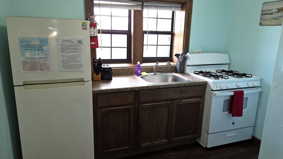 The full kitchen has a refrigerator/freezer, gas stove, and kitchen basics