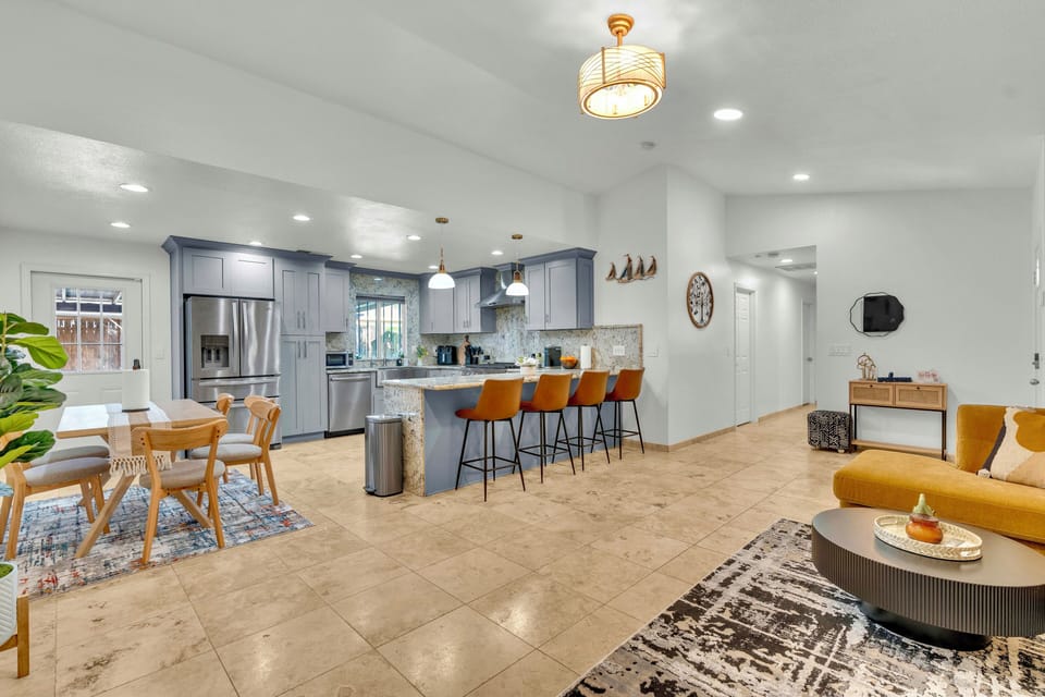 Bright, airy living room with modern decor, breakfast bar, ideal for family fun!