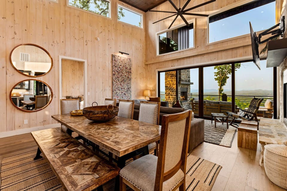 Gather in the dining area with farmhouse table, Smart TV, and mountain views.
