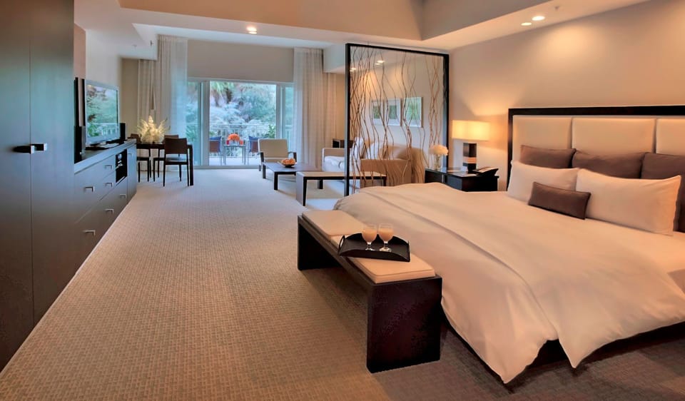 Bright sleeping area featuring a plush bed, ample floor space, and easy access to the living and outdoor areas.