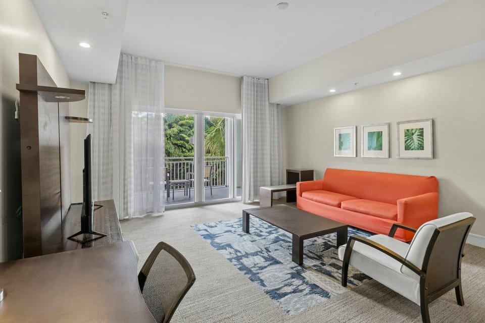 Bright living area with a comfortable sofa, modern décor, and natural light creating a welcoming space to relax.