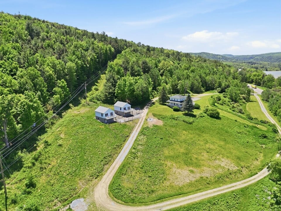 Aerial View | Wooded Hillside Setting | Dual Structures & Gravel Driveway