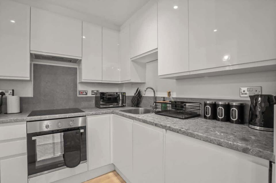 Fully Equipped Kitchen: A modern kitchen featuring quality appliances, including a dishwasher and washing machine for added convenience during your stay.