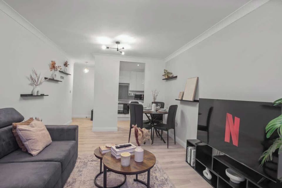 Living Room: Bright and airy space perfect for movie nights or intimate dinners with friends!