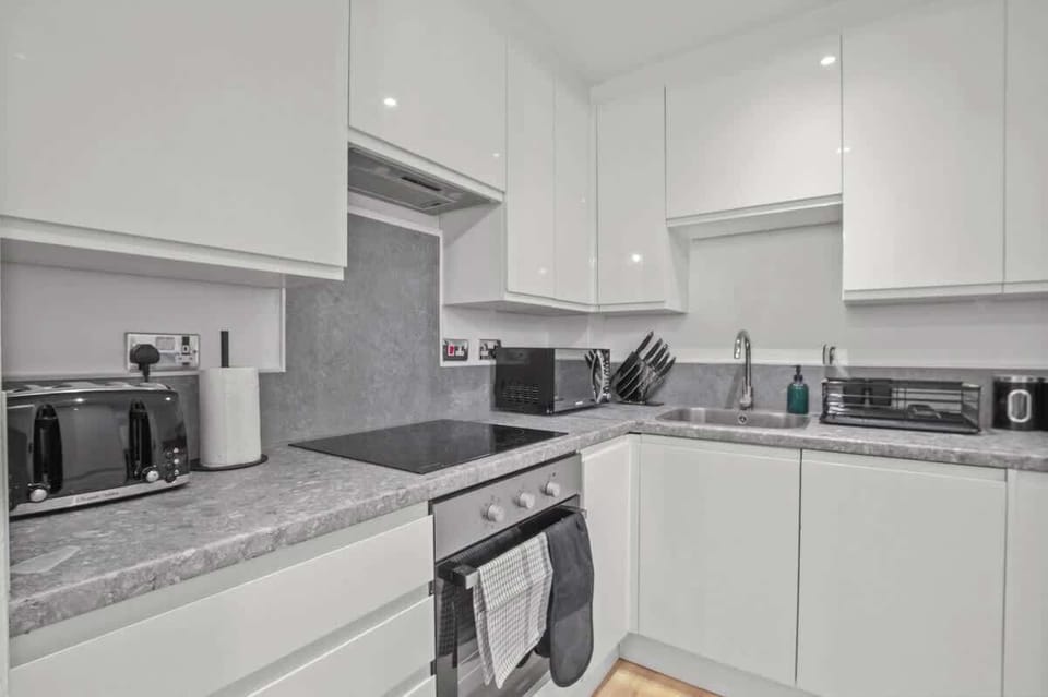 Fully Equipped Kitchen: A modern kitchen featuring quality appliances, including a dishwasher and washing machine for added convenience during your stay.