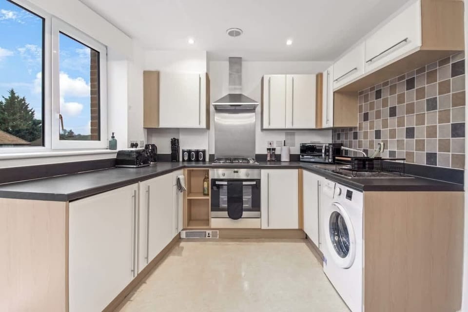 Fully Equipped Kitchen: Featuring an oven, hob, microwave, washing machine, and everything you need to cook during your stay.