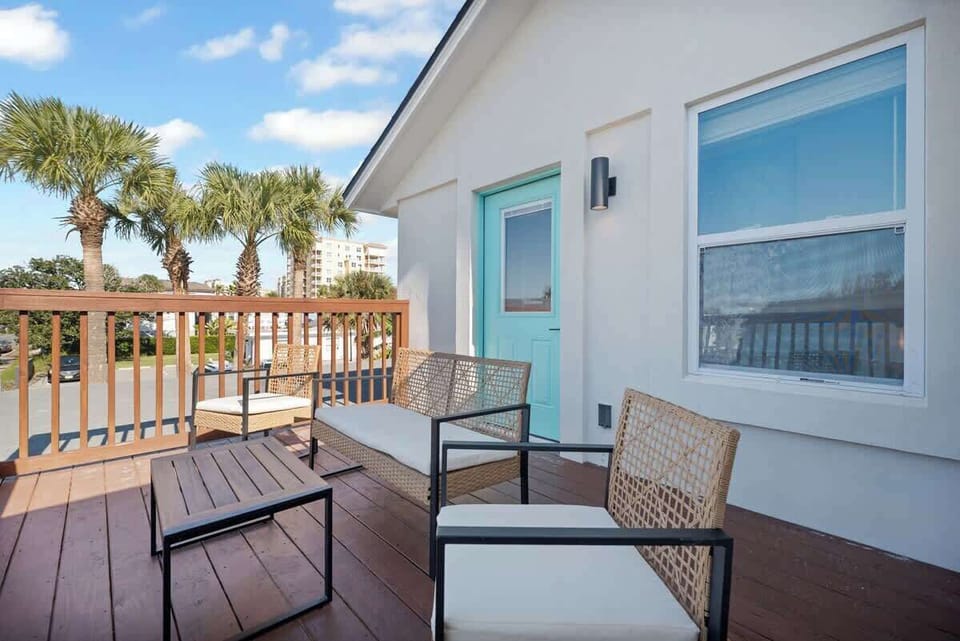 private balcony off the large bedroom with comfortable outdoor seating with beautiful views