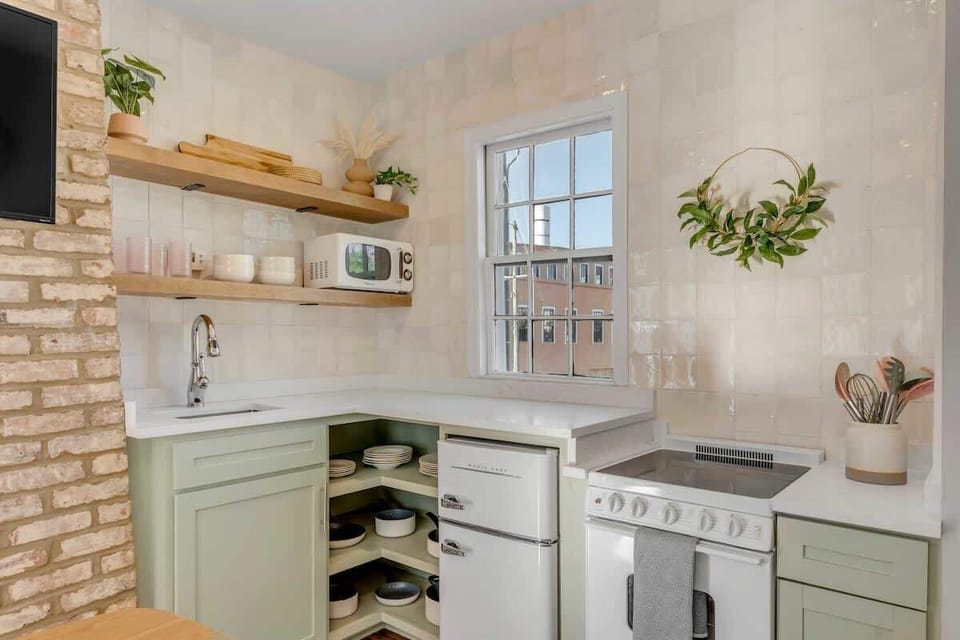 Fully equipped kitchen stocked with cookware, dining essentials, and modern appliances.
