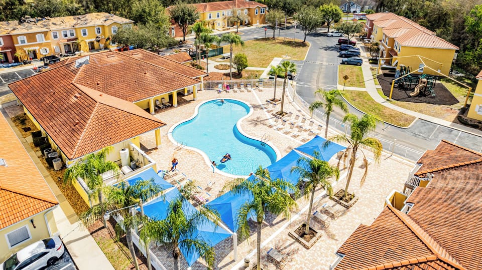 Aerial views of Lake Berkley Resort showing the pool, clubhouse, playground, lakes, and surrounding vacation homes.