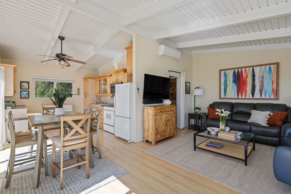 Upstairs, the main living space is filled with natural light and bright views.