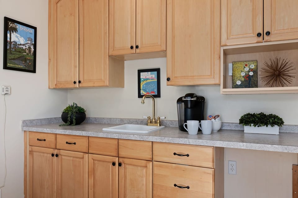 Coffee bar with sink & cabinet storage.