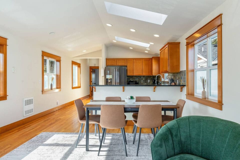 Open dining area w/ seating for 6, skylights & warm wood floors — great for shared meals.