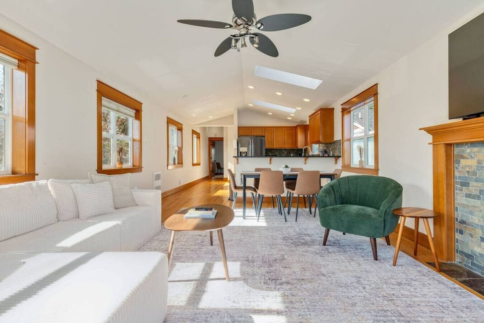 Airy living & dining space w/ vaulted ceilings, a comfy sofa & room to gather.