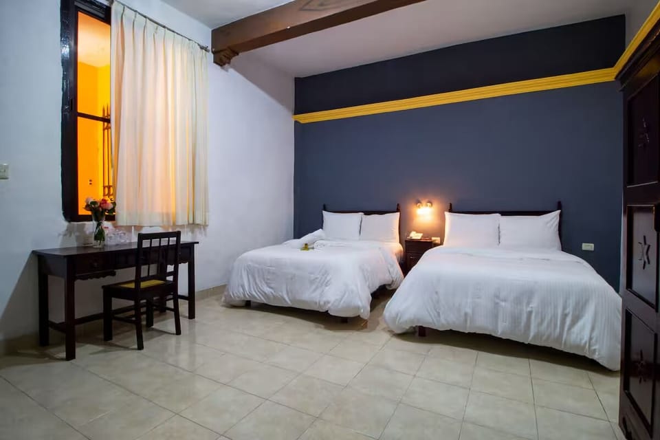 Unwind in crisp beds under warm lights and beams.