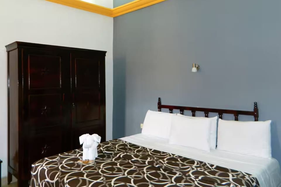 Drift off in a calm room with neatly made bedding.