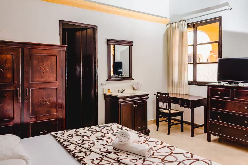 Unwind in a bright room with desk and easy comfort.