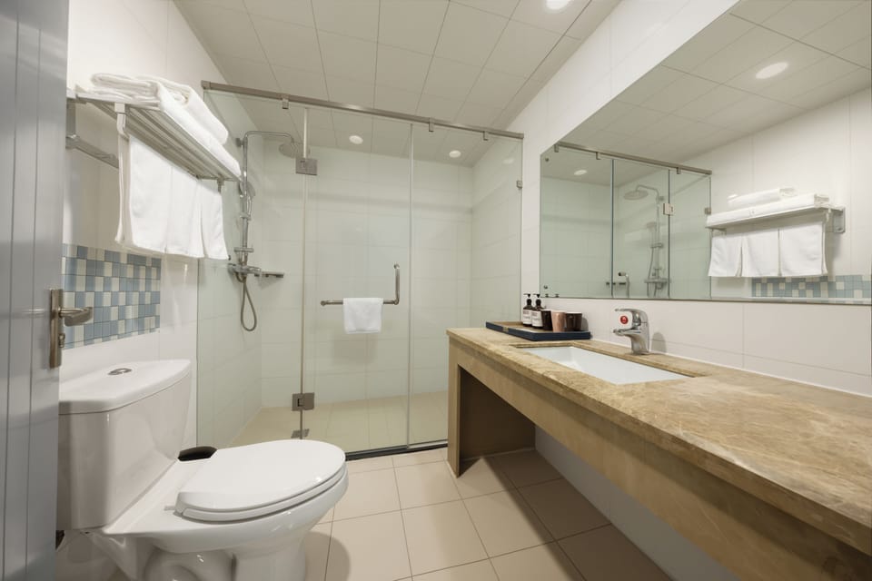 Shower, hair dryer, slippers, towels